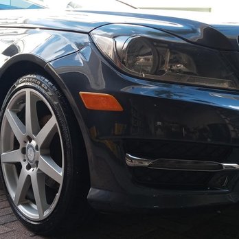 Blue sports car front quarter view showing headlight, wheel, and side panel