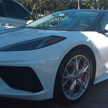 White sports car with sleek design parked at outdoor event